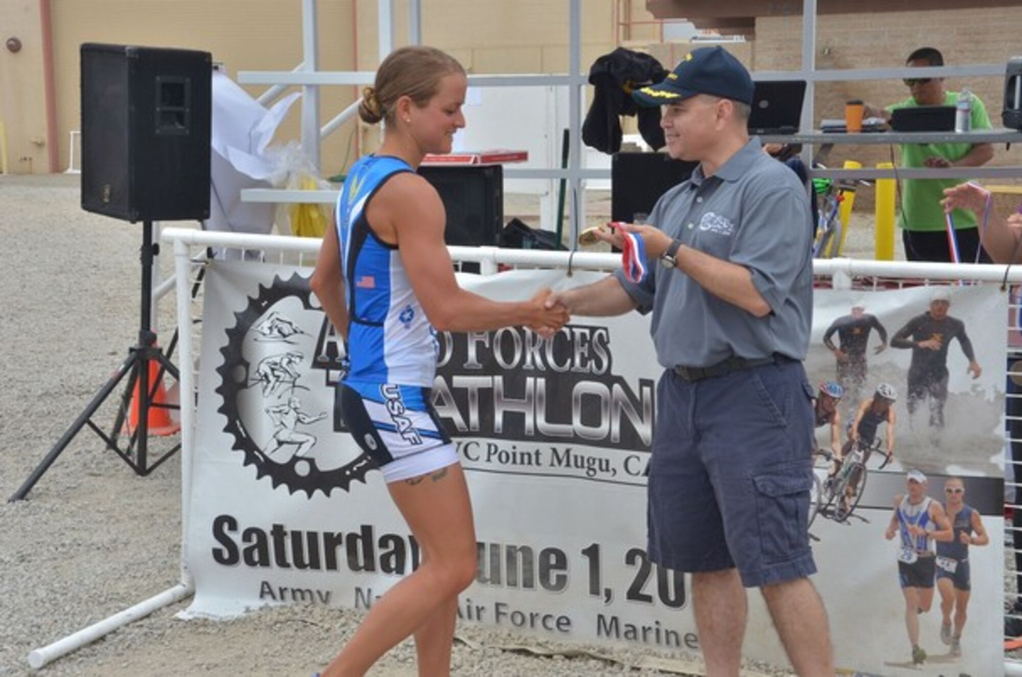 U.S. Air Force 2nd Lt. Samantha Morrison accepts her gold medal from Capt. Larry Vasquez, commanding officer of Naval Base Ventura County, June 1, 2013.  Morrison, who had graduated three days earlier from the U.S. Air Force Academy, won the Armed Forces National Championships in her first race as an active duty Air Force officer. (Courtesy Photo)
