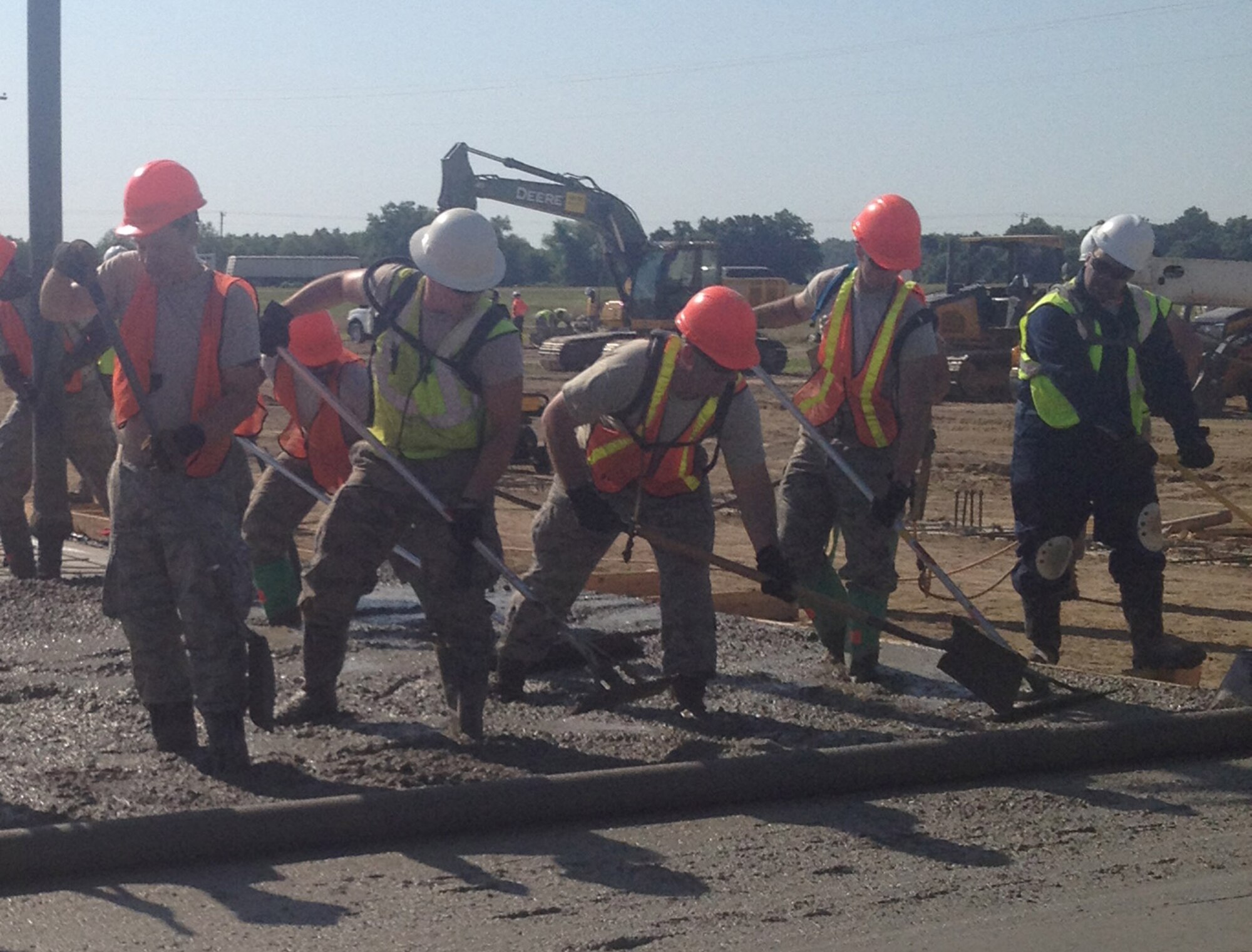 Shown wearing orange hard hats, Air Force Reserve Technical Sgt. Kevin Dillon,
Senior Airman Paul Tanner and Airman 1st Class Brandon Barbe, members of the 910th
Civil Engineer Squadron, level wet concrete to ensure even dispersion June
14, 2013, here.  Twenty-four 910th Citizen Airmen teamed up with the 555th Red Horse Unit, Nellis AFB, 436th Civil Engineer Squadron, Dover AFB and the 919th Civil Engineer Squadron from Duke Field to pour and form approximately 100 yards of concrete in preparation to build an aircraft hangar. (U.S. Air Force photo/Senior Airman Heather Burge)
