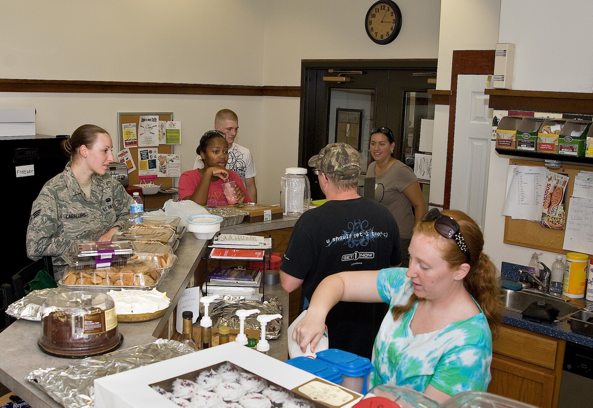 Members of the 436th Airlift Wing staff agencies prepare food June 26, 2013 in the kitchen of the Eagle's Net Cafe on Dover Air Force Base, Del. The WSA hosted a home cooked meal for dorm residents. (U.S. Air Force photo/Roland Balik)