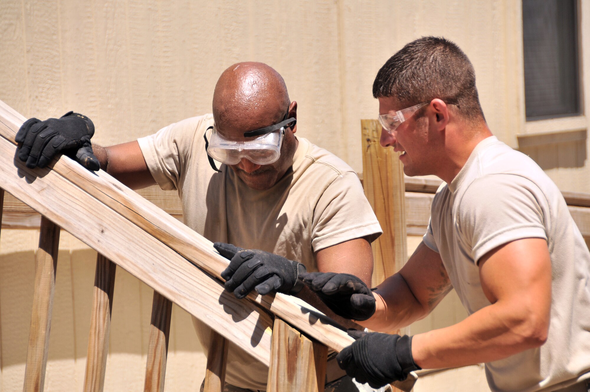 Master Sgt. Jonathan Allen and Staff Sgt. Alex Zeman, members of  the 131st Civil Engineer Squadron, take the back railing off a leased trailer June 26, 2013, at Whiteman Air Force Base, Mo. The trailer was previously used by squadrons that are being deactivated. (U.S. Air National Guard photo by Senior Master Sgt. Mary-Dale Amison/Released) 