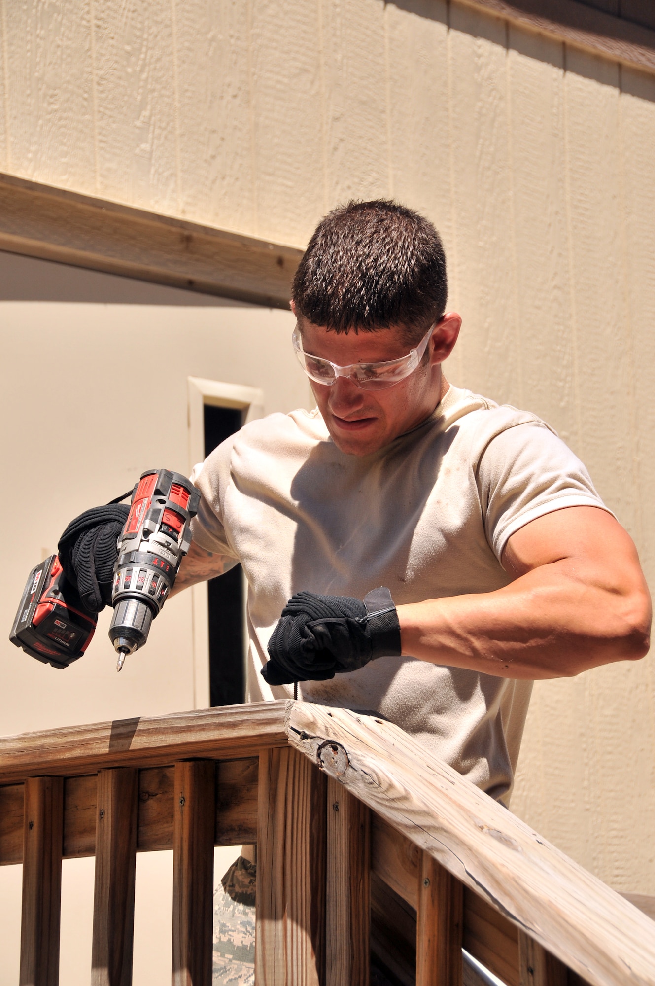 Staff Sgt. Alex Zeman, a heating, ventilation and air conditioning journeyman with the 131st Civil Engineer Squadron, removes screws from the back deck of a leased trailer June 26, 2013, at Whiteman Air Force Base, Mo. Zeman and two other Airmen from his squadron traveled here from Lambert Air Guard Station near St. Louis to team up with the 509th CES and get the trailer back to its owner. (U.S. Air National Guard photo by Senior Master Sgt. Mary-Dale Amison/Released) 