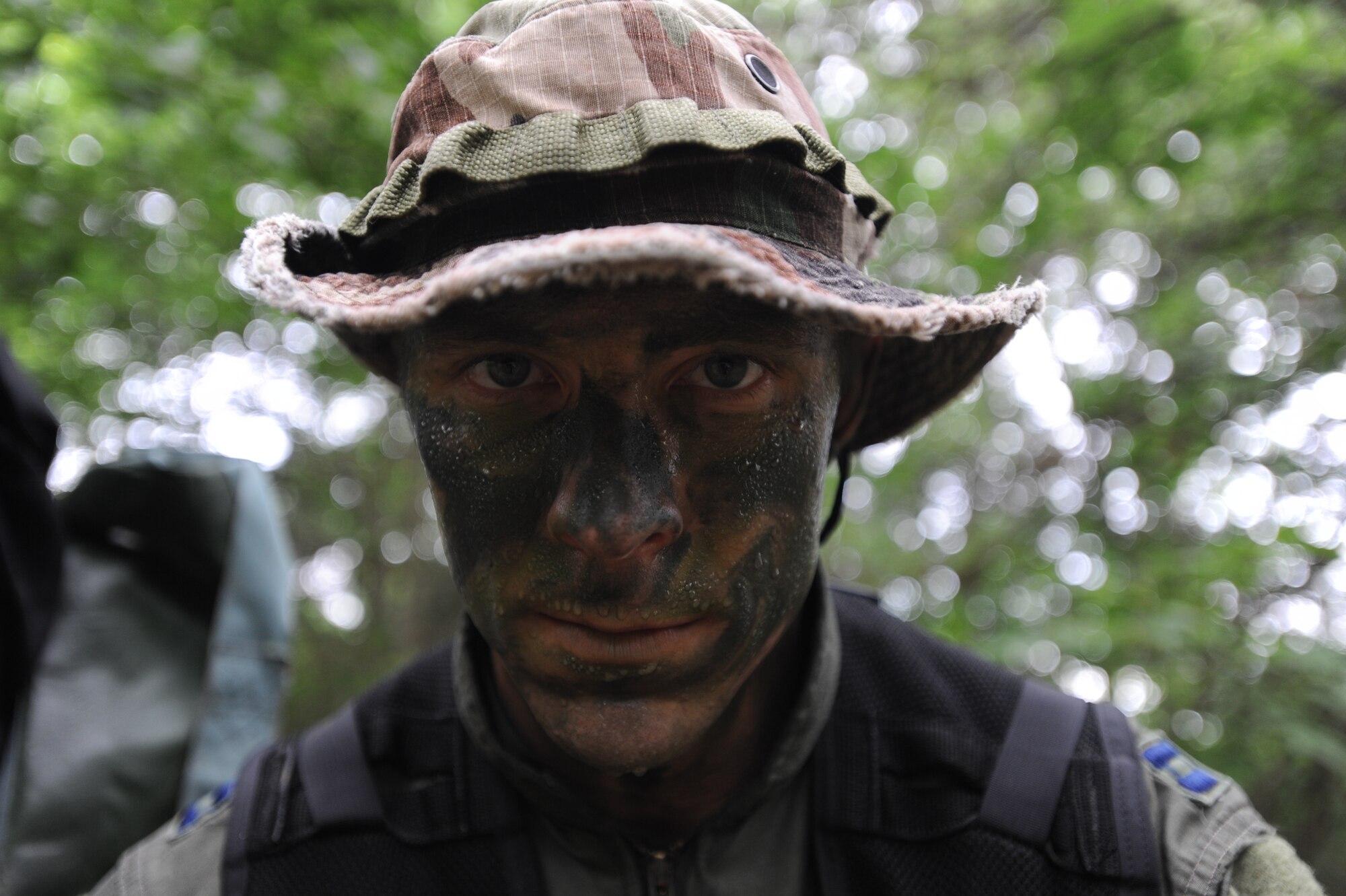 Captain Jonathon Roe, 393rd Bomb Squadron B-2 Spirit pilot, takes a breather during survival training, Whiteman Air Force Base, Mo., June 27, 2013. The training consisted of evading enemies after landing on the ground and using land navigation skills to reach safe haven. (U.S. Air Force photo by Staff Sgt. Alexandra M. Boutte/Released)
