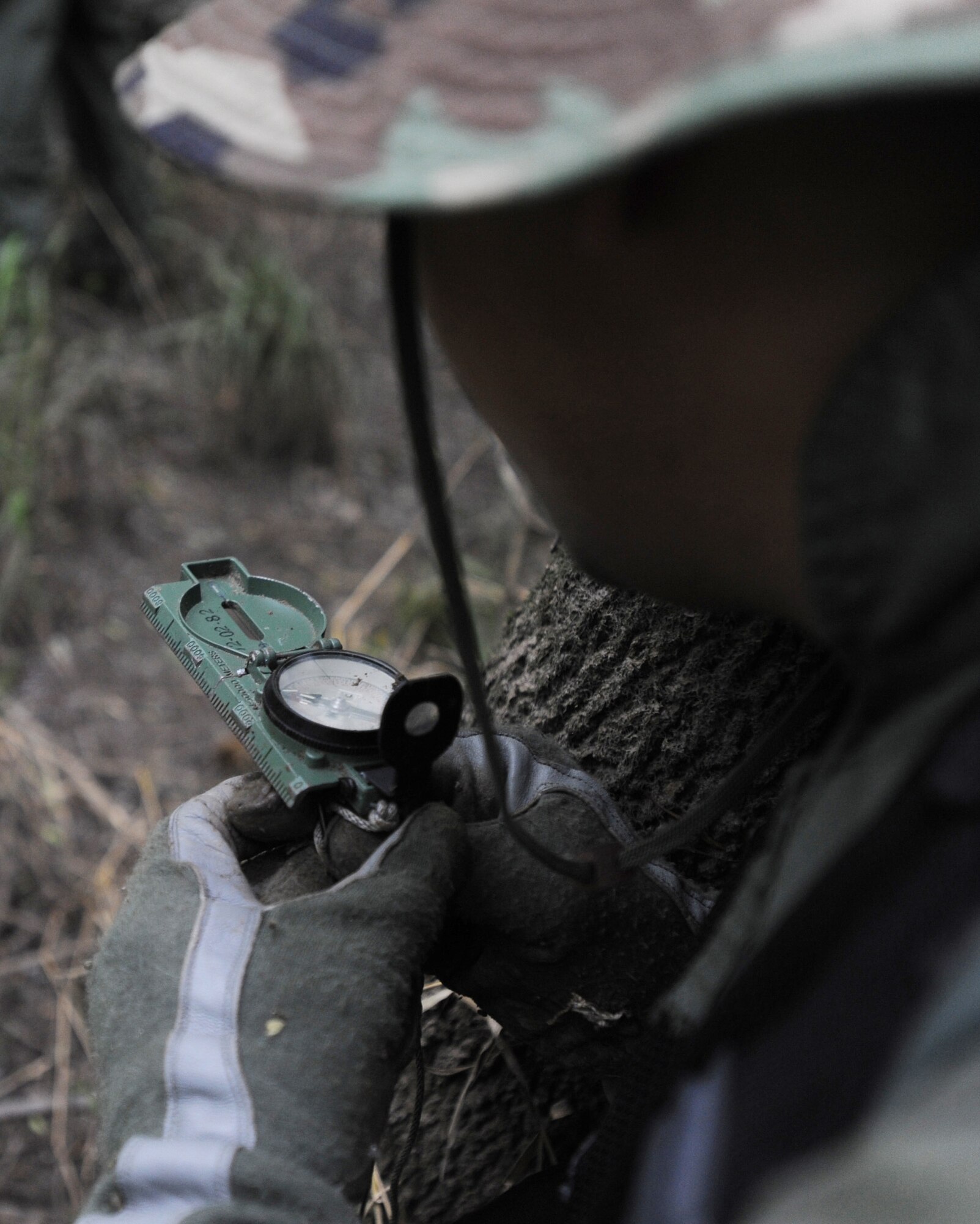 Capt. Michael Ramamurthy, 393rd Bomb Squadron B-2 Spirit pilot, uses his GPS to guide him and his team to a simulated rescue site, Whiteman Air Force Base, Mo., June 27, 2013. Instructors created a downed-crew scenario which is centered around either an aircraft being shot down, an impending crash or an ejection from the aircraft.  (U.S. Air Force photo by Staff Sgt. Alexandra M. Boutte/Released)
