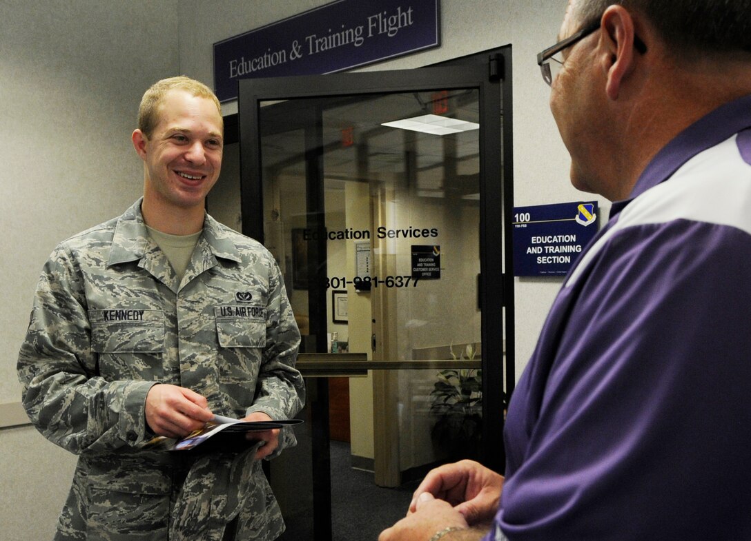 Airman 1st Class Matt Kennedy, 11th Civil Engineering Squadron engineering assistant talks to Tim Snapp, Bellevue University Military Outreach manager at the Blood Drive Mini Education Fair on Joint Base Andrews, Md., June 26, 2013. The education center had more than 10 college representatives attend to inform service members of their school benefits and opportunities. (U.S. Air Force photo/Airman 1st Class Nesha Humes)