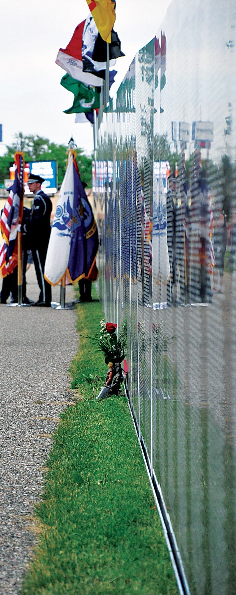 Flowers rest against the base of the Traveling Vietnam Memorial Wall, which was on display in Lions Park, Cheyenne, Wyo., from June 20 through June 23, 2013. (U.S. Air Force photo by Senior Airman Mike Tryon)