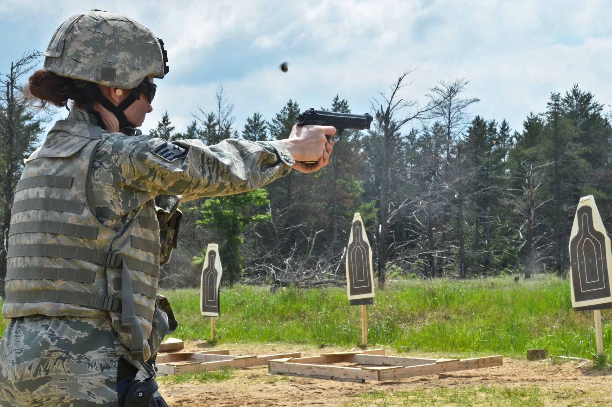 U.S. Air Force Staff Sgt. Linda Kosterman, a security forces member with the 128th Air Refueling Wing, Wisconsin Air National Guard, fires an M9 pistol during a weapons qualification course at Fort McCoy, Wis., June 10, 2013.  Members of the 128th Security Forces Squadron conducted annual training at Total Force Training Center Fort McCoy.  (U.S. Air National Guard photo by Staff Sgt. Jenna Hildebrand/Released)