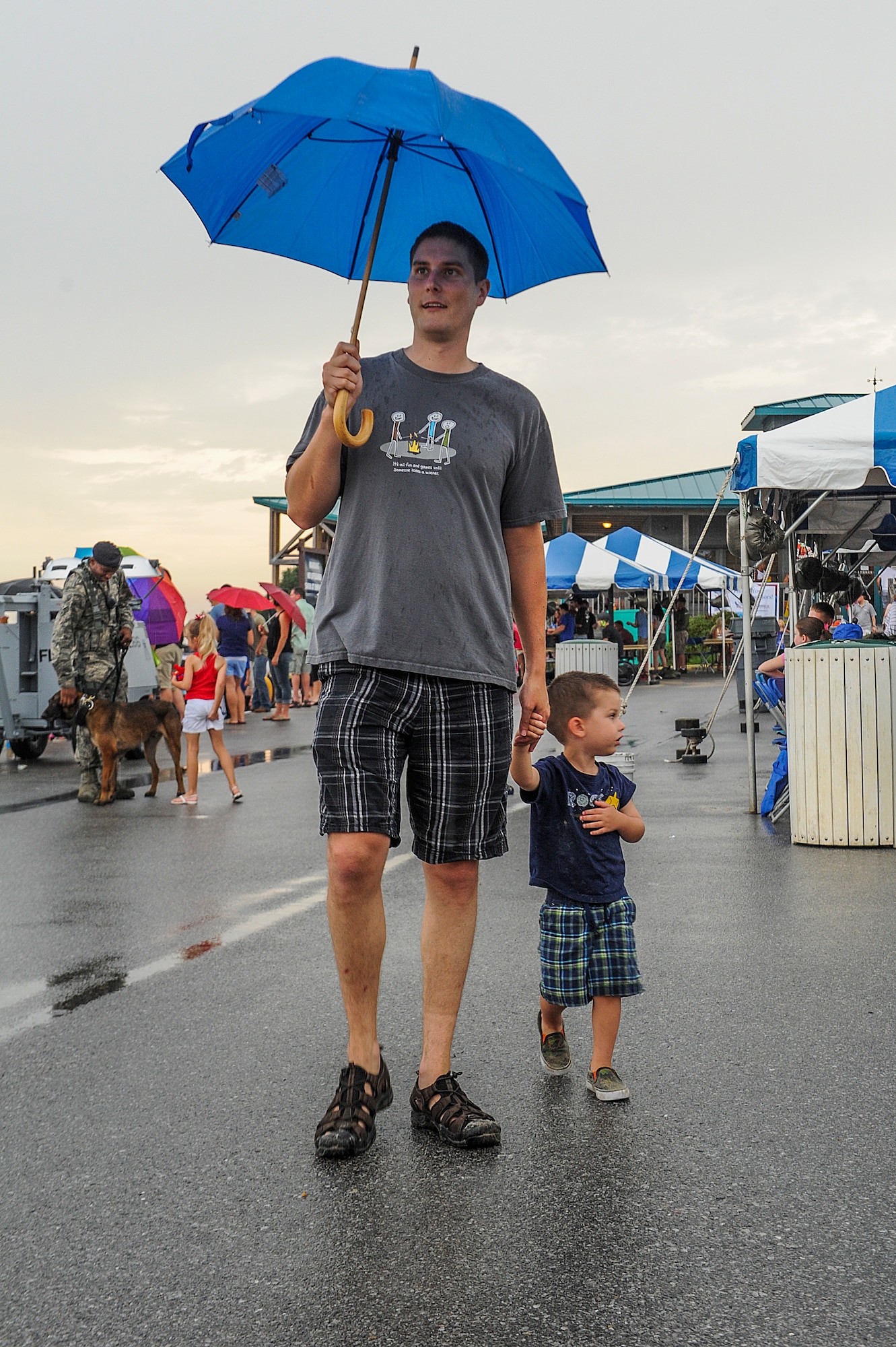Staff Sgt. Luke Schaefer, 25th Intelligence Squadron, walks with his son at the beginning of the 18th Annual Sound of Independence celebration at the Soundside Marina on Hurlburt Field, Fla., June 28, 2013. The celebration had various booths set up to provide food, fun and explain all the new services Hurlburt Field has established in the last year. (U.S. Air Force photo/Airman 1st Class Christopher Callaway) 