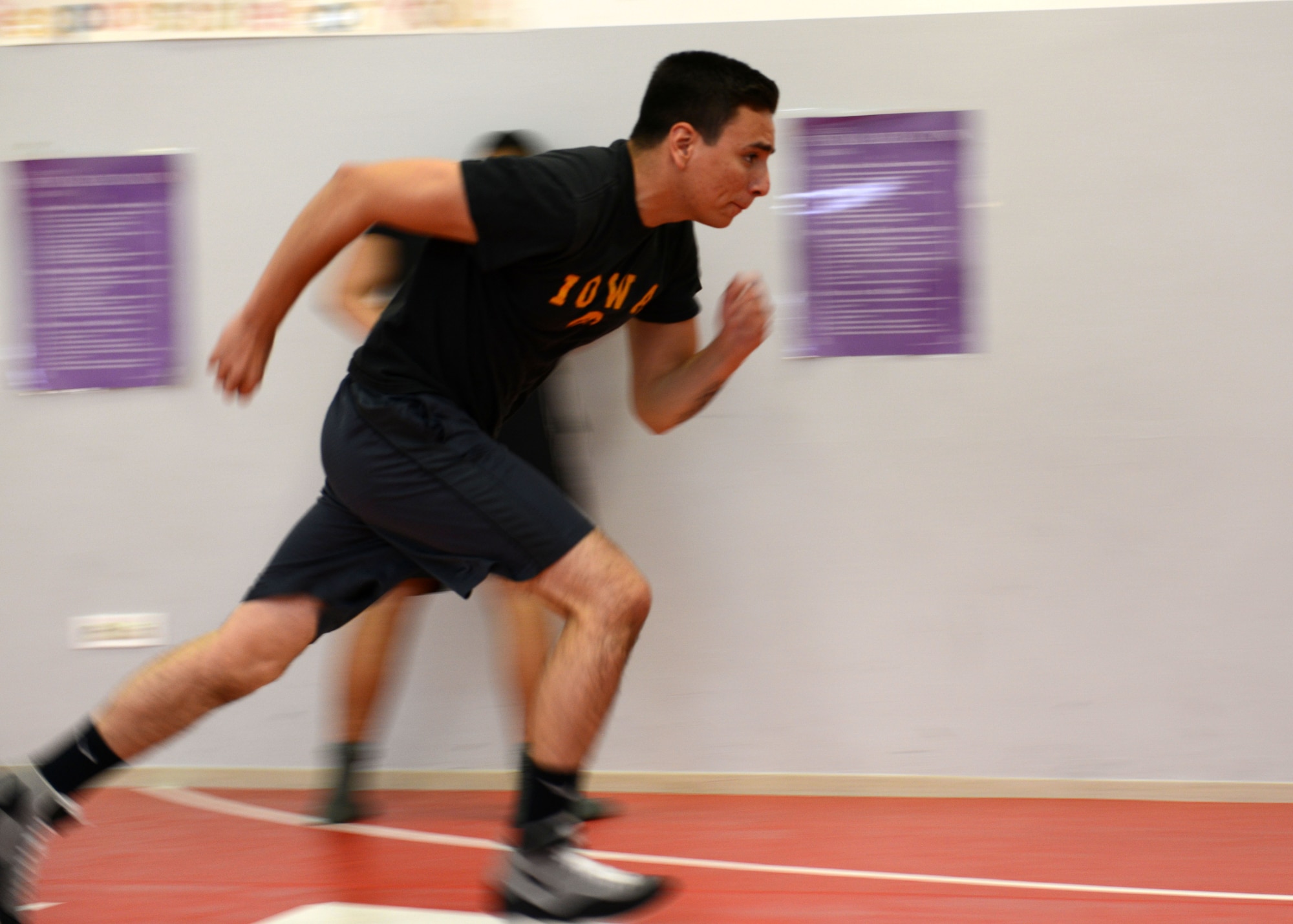 Zachary Gonzalez sprints before a wrestling club practice June 5, 2013, at Aviano Air Base, Italy. The club’s mission is to promote the sport of amateur wrestling, goal setting, achievement, sportsmanship and international relations through local, regional, inter-service, and international competition. (U.S. Air Force photo/Airman Ryan Conroy) 