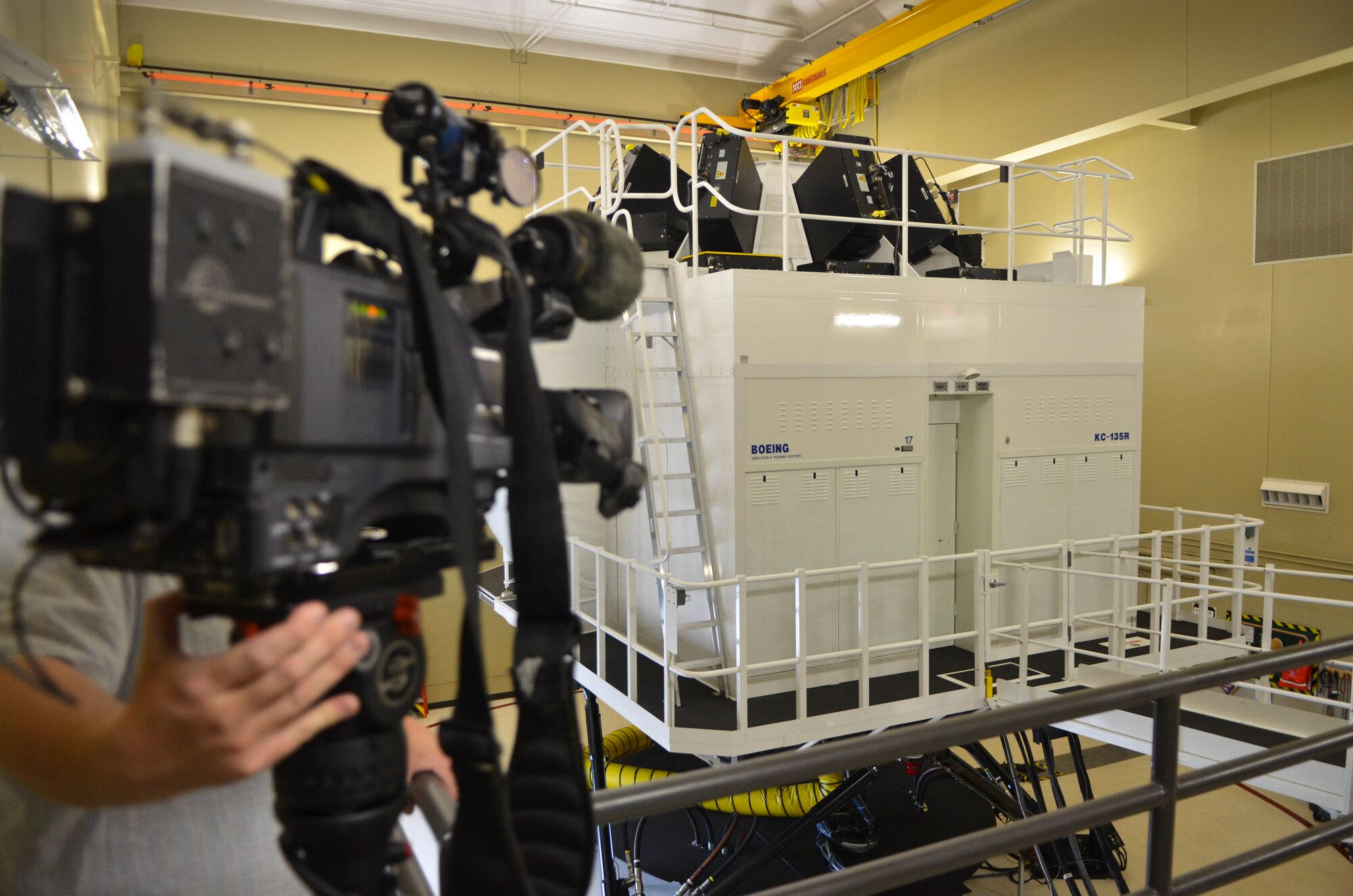 News crews from Milwaukee Wisconsin capture footage of a KC-135R simulator at the 128th Air Refueling Wing, Wisconsin Air National Guard,  June 28, 2013. The Milwaukee news teams were invited to attend a media engagement event at the air wing to learn more about the KC135R flight simulator and phase maintenance of the KC135R aircraft. (U.S. Air Force photo by Senior Master Sgt. Jeff Rohloff/Released)