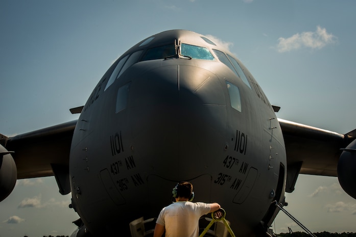 Senior Airman Clayton Valentine, 437th Maintenance Group jet-propulsion specialist, wears a head set to communicate with his team members who are in the cockpit of a C-17 Globemaster III during a routine engine check  June 26, 2013, at Joint Base Charleston – Air Base, S.C. Airmen from the 437th MXG perform routine maintenance to  C-17s daily. (U.S. Air Force photo/ Senior Airman Dennis Sloan)