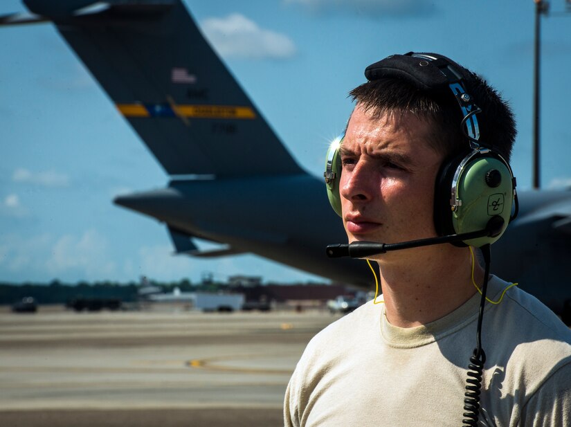 Senior Airman Clayton Valentine, 437th Maintenance Group jet-propulsion specialist, wears a head set to communicate with his team members who are in the cockpit of a C-17 Globemaster III during  a routine engine check  June 26, 2013, at Joint Base Charleston – Air Base, S.C. Airmen from the 437th MXG perform routine maintenance to  C-17s daily. (U.S. Air Force photo/ Senior Airman Dennis Sloan)
