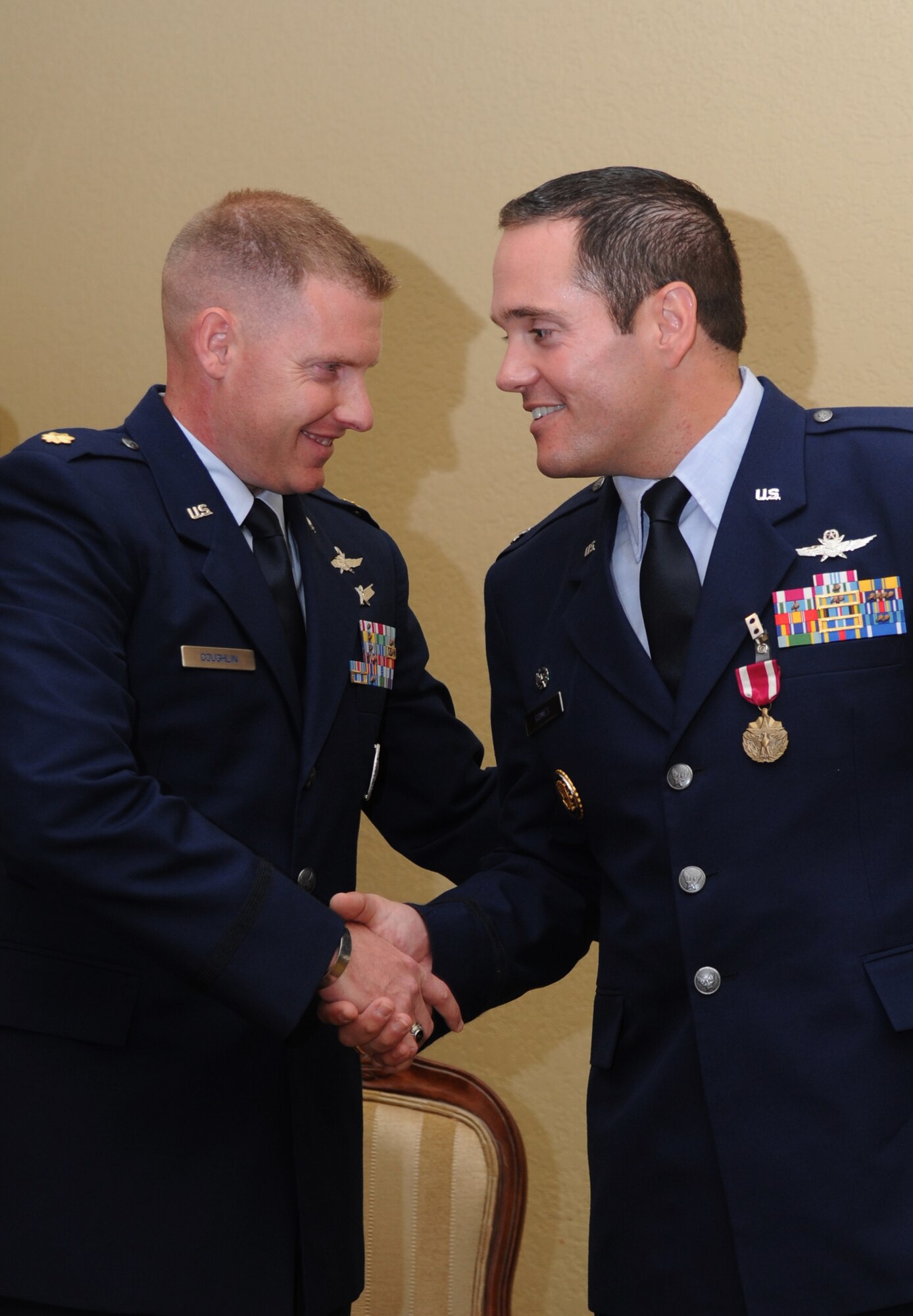Maj. James Coughlin, incoming 85th Engineering Installation Squadron commander, is congratulated by Lt. Col. Jeffrey Gomes, outgoing 85th EIS commander, during a change of command ceremony June 28, 2013, at the Bay Breeze Event Center, Keesler Air Force Base, Miss.  Col. Cynthia Wright, Cyberspace Engineering Installation Group commander, Tinker Air Force Base, Okla., was the presiding officer for the event.  (U.S. Air Force photo by Kemberly Groue)