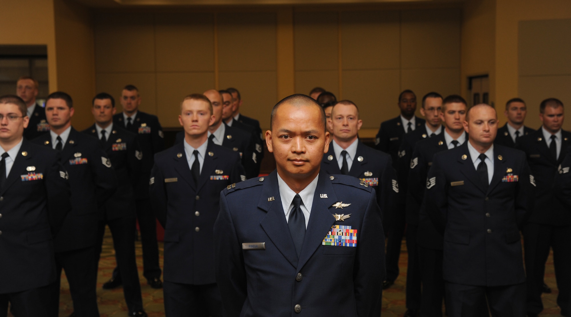 Capt. Arris Pineda, 85th Engineering Installation Squadron director of operations, stands in formation preparing to delivering a final salute to the outgoing commander and a first salute to the incoming commander during a change of command ceremony for the 85th EIS June 28, 2013, at the Bay Breeze Event Center, Keesler Air Force Base, Miss.  Maj. James Coughlin is the incoming commander and Lt. Col. Jeffrey Gomes was the outgoing commander.  (U.S. Air Force photo by Kemberly Groue)