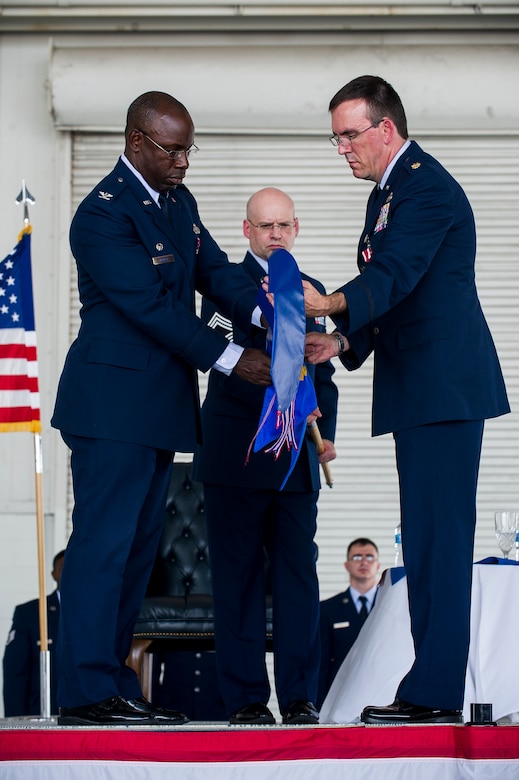 Colonel Dennis Dabney, 437th Maintenance Group commander, and Maj. Matthew Manns, 437th Maintenance Operations Squadron commander, sheath the 437th MOS guidon, symbolizing the unit's inactivation during the 437th Maintenance Operations Squadron inactivation ceremony June 28, 2013, at Joint Base Charleston – Air Base, S.C. The 437th MOS was activated in October 2002. (U.S. Air Force photo/ Senior Airman George Goslin)

