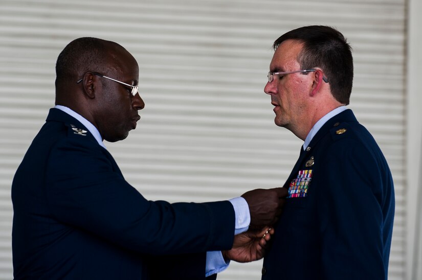 Col. Dennis Dabney, 437th Maintenance Group commander, pins the Meritorious Service Medal on Maj. Matthew Manns, 437th Maintenance Operations Squadron commander, during the 437th Maintenance Operations Squadron inactivation ceremony June 28, 2013, at Joint Base Charleston – Air Base, S.C. The 437th MOS activated in October 2002. (U.S. Air Force photo/ Senior Airman George Goslin)
