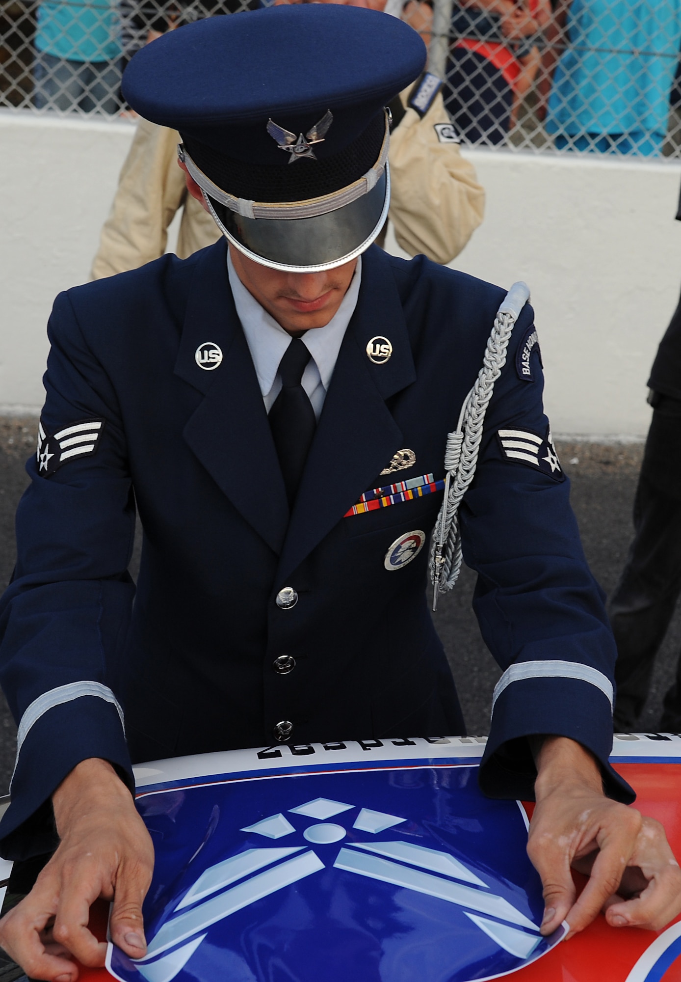 U.S. Air Force Senior Airman Brandon Rose, ceremonial guardsman with the Langley Air Force Base, Va. Honor Guard, places a decal on the race car representing the U.S. Air Force in the Commander’s Race at Langley Motor Speedway in Hampton Va., June 29, 2013. Each military branch was represented in the Commander’s Race by the top-five racers of the evening. (U.S. Air Force photo by Airman 1st Class Victoria H. Taylor/Released) 