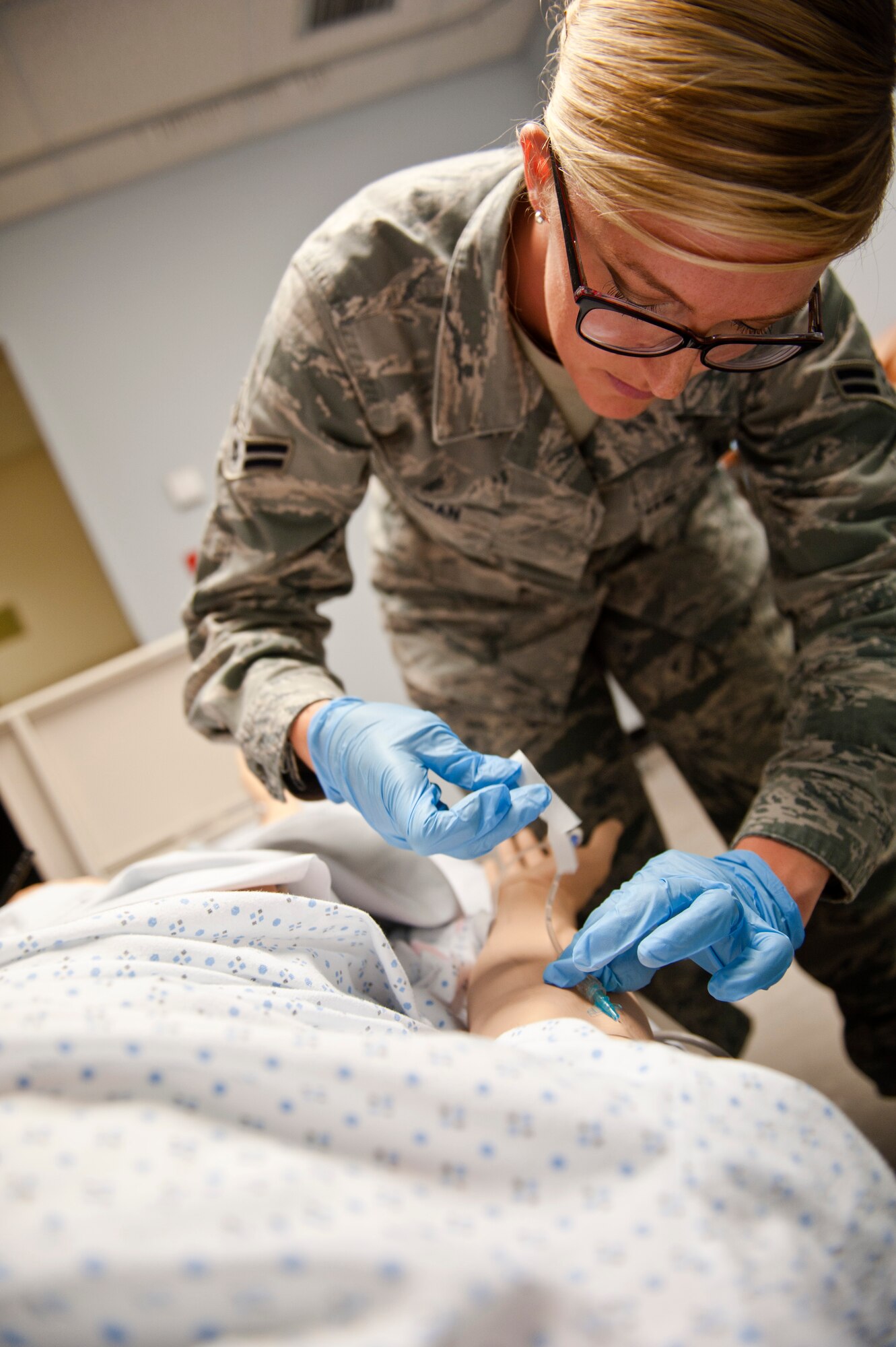 Airman 1st Class Valerie Essman, 39th Medical Operations Squadron ambulance serviceman, places an IV into a Sim Man medical dummy June 19, 2013, at Incirlik Air Base, Turkey. The Sim Man gives Airmen the opportunity to train on various scenarios in a realistic environment. (U.S. Air Force photo by Senior Airman Daniel Phelps/Released)
