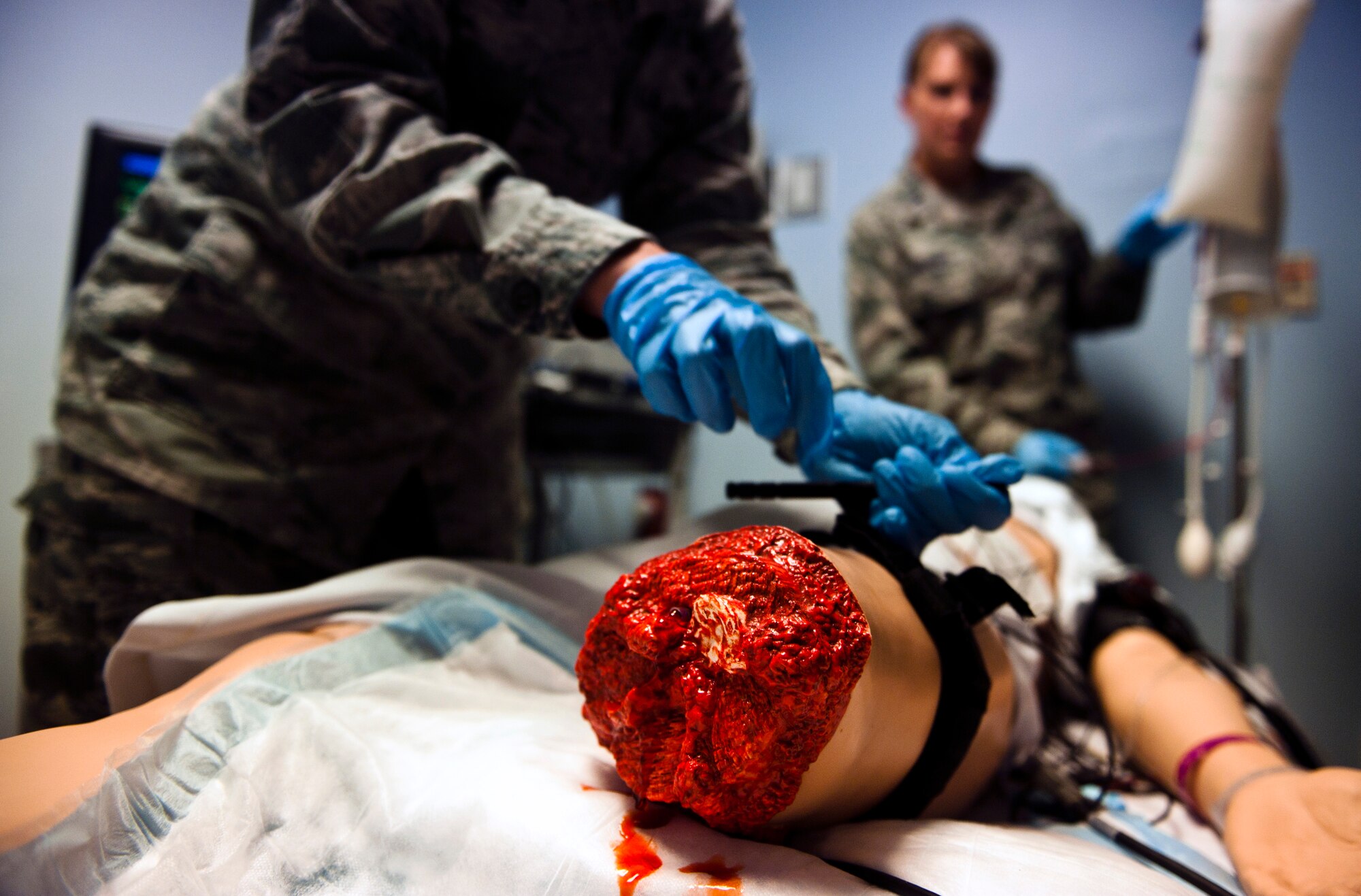 Airman 1st Class Valerie Essman, 39th Medical Operations Squadron ambulance serviceman, applies a tourniquet to a Sim Man medical dummy to keep it from bleeding out June 19, 2013, at Incirlik Air Base, Turkey. The Sim Man gives Airmen the opportunity to train on a controlled human-like patient. (U.S. Air Force photo by Senior Airman Daniel Phelps/Released)