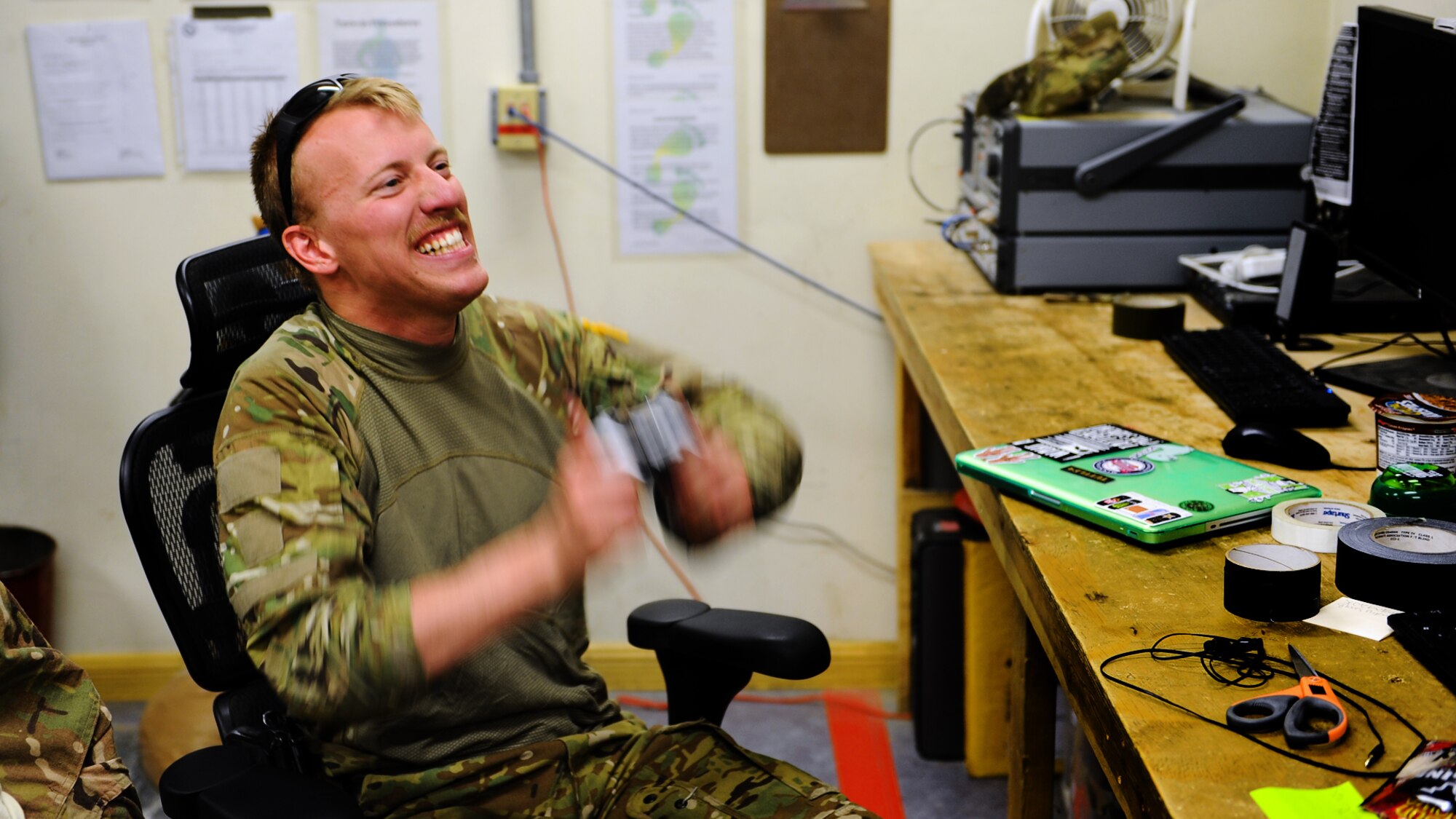 Airman 1st Class Sven Raemer, a special mission aviator with the 83rd Expeditionary Rescue Squadron, burns some energy playing video games while waiting for a mission to drop at Bagram Airfield June 17, 2013. Raemer was born in West Berlin, Germany, before he and his family moved to Colorado in 1993. He is deployed from RAF Lakenheath, England. (U.S. Air Force photo/Tech. Sgt. Raymond Hoy)