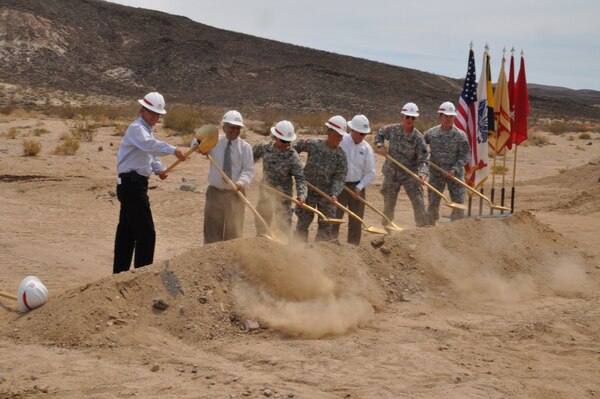 (From left) John Keever, Muhammad Bari, Command Sgt. Maj. Dale Perez, Col. Mark Toy, Peter Tunnicliffe, Brig. Gen. Ted Martin and Col. Kurt Pinkerton break ground during a ceremony June 28 commemorating the start of construction of the new water treatment plant at the National Training Center at Fort Irwin, Calif. The U.S. Army Corps of Engineers Los Angeles District is overseeing the construction of the design-build effort by CDM
Smith Construction to provide six million gallons of water per day to the inhabitants of the NTC. (Photo by Brooks O. Hubbard IV)