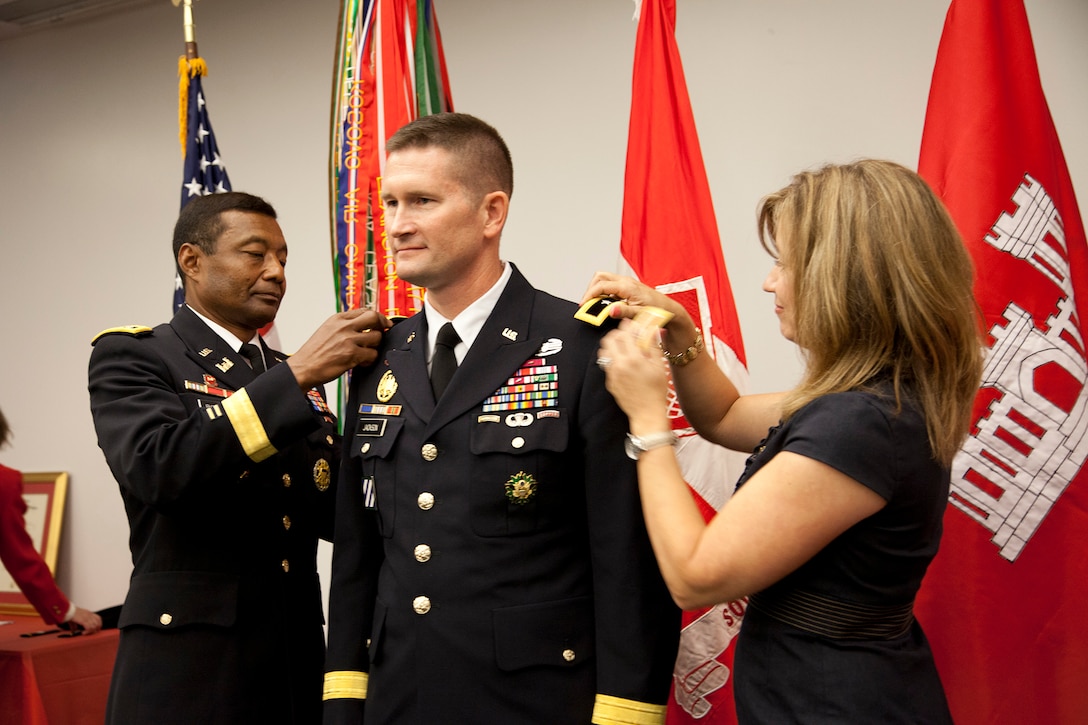 South Atlantic Division Commander Ed Jackson has stars representing Brigadier General rank pinned on his uniform by Chief of Engineers LTG Thomas Bostick and BG Jackson's wife, Lynne, in a ceremony in Atlanta on July 1.