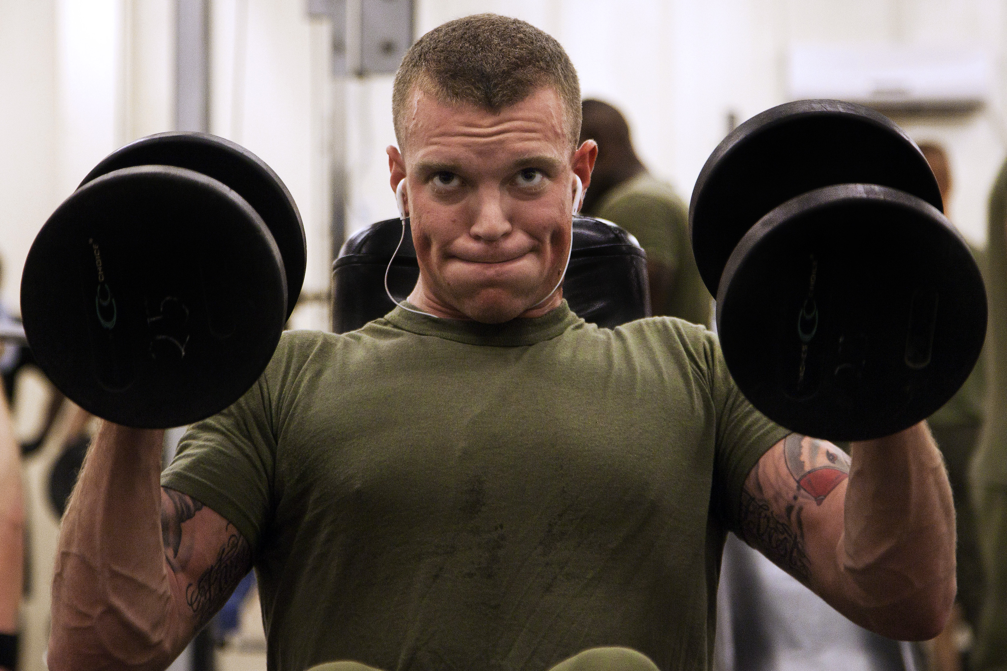 U.S. Marine Corps Cpl. Martine Witman lifts weights in the fitness