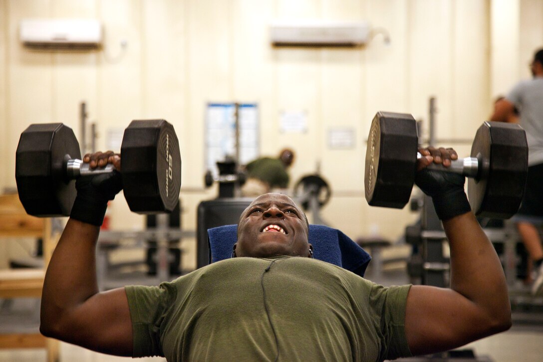 U.S. Marine Crops Cpl. Daniel Pritchett performs dumbbell incline presses in the fitness center on Camp Leatherneck in Helmand province, Afghanistan, June 28, 2013. 
Pritchett, assigned to Georgian Liaison Team-9, works out to maintain his physical fitness and operational readiness.