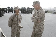 Following an awards ceremony, Staff Sgt. Nicholas Singh, left, discusses the chain of events that led to being awarded the Purple Heart medal with Brig. Gen. Niel E. Nelson June 27 at Camp Kinser. Singh earned the award for injuries sustained while supporting Operation Enduring Freedom in Afghanistan. Nelson is the commanding general of 3rd Marine Logistics Group, III Marine Expeditionary Force, and Singh is a maintenance chief with 3rd Maintenance Battalion, Combat Logistics
Regiment 35, 3rd MLG, III MEF.