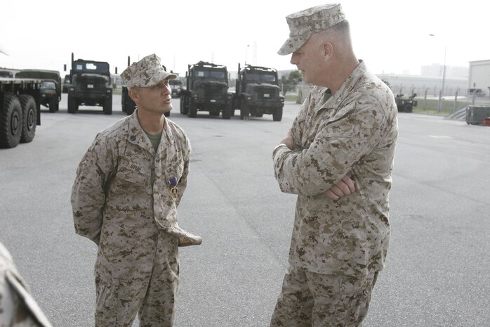 Following an awards ceremony, Staff Sgt. Nicholas Singh, left, discusses the chain of events that led to being awarded the Purple Heart medal with Brig. Gen. Niel E. Nelson June 27 at Camp Kinser. Singh earned the award for injuries sustained while supporting Operation Enduring Freedom in Afghanistan. Nelson is the commanding general of 3rd Marine Logistics Group, III Marine Expeditionary Force, and Singh is a maintenance chief with 3rd Maintenance Battalion, Combat Logistics
Regiment 35, 3rd MLG, III MEF.
