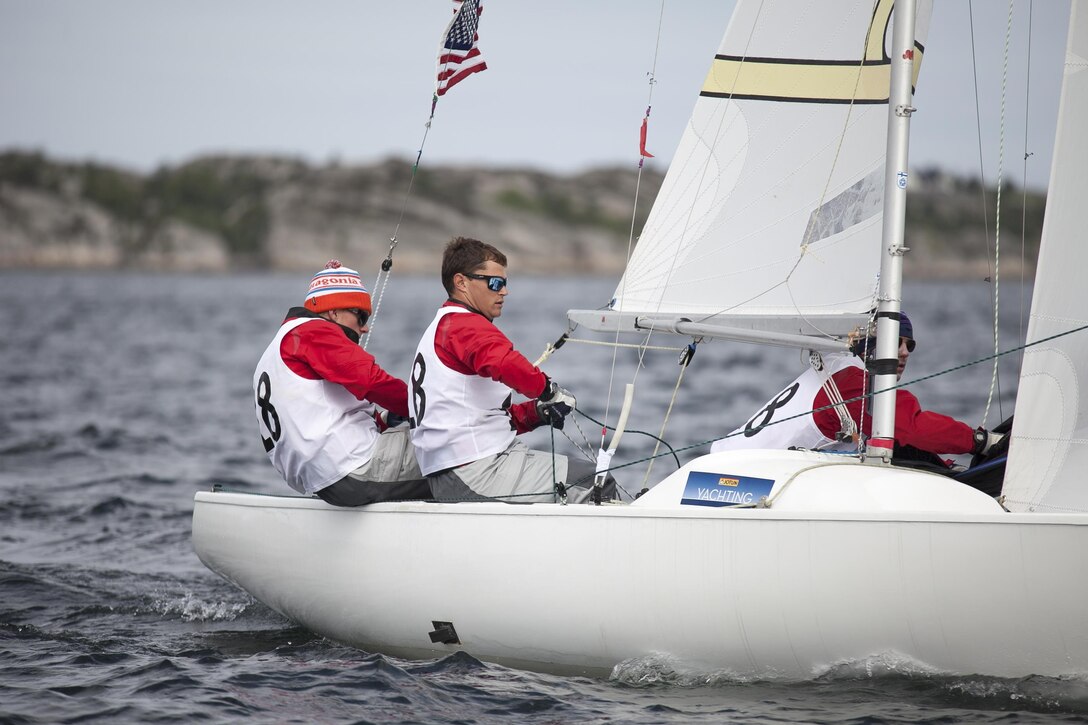 US Men take sail during the 2013 CISM World Military Sailing Championship 27 June to 4 July at the Askoy Yacht Club in Bergen, Norway.  (Left to right) Skipper ENS Taylor Vann, LTJG Jonathan Duffet, and LCDR Luke Suber.