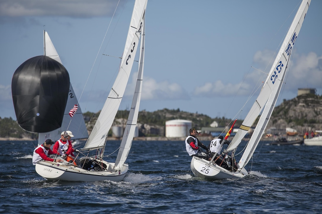 Team USA Men led by skipper ENS Taylor Vann are make their move in an attempt to pass Team Spain during the 2013 CISM World Military Sailing Championship at the Askoy Yacht Club in Bergen, Norway 27 June to 4 July.  