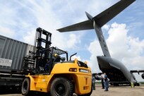 Sailors off-load oil spill containment equipment from a C-17 at Naval Air Station Joint Reserve Base (NAS JRB) New Orleans.  Air Force C-17s, from Anchorage, Alaska, delivered the equipment to support Deepwater Horizon oil spill response. Deepwater Horizon was an ultra-deepwater oil rig located 130 miles southeast of New Orleans that exploded April 20 and sank April 22, causing a massive oil spill threatening the U.S. Gulf Coast.  