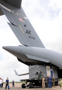 Sailors off-load oil spill containment equipment from a C-17 at Naval Air Station Joint Reserve Base (NAS JRB) New Orleans.  Air Force C-17s, from Anchorage, Alaska, delivered the equipment to support Deepwater Horizon oil spill response. Deepwater Horizon was an ultra-deepwater oil rig located 130 miles southeast of New Orleans that exploded April 20 and sank April 22, causing a massive oil spill threatening the U.S. Gulf Coast.  
