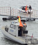 A Navy port security craft investigates a suspicious boat as part of a training scenario during Citadel Protect 2010(CP10).  CP10 is part of the Navy's regular training designed to asses the Navy's capability to protect waterborne assets against vessel borne and/or Improvised Explosive Device (IED) threats in Navy ports.  CP10 is a coordinated event between U.S. Fleet Forces and Commander, Navy Installations Command (CNIC).   