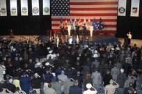 Members of the audience salute as the Canadian and U.S. national anthems are played at the North American Aerospace Defense Command and U.S. Northern Command change of command ceremony at Peterson Air Force Base, Colo., May 19. Navy Adm. James Winnefeld assumed leadership of the commands from Air Force Gen. Gene Renuart. 