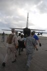 Medical personnel from New York,Tennessee, and Hawaii Disaster Medical Assistant Team (DMAT), and U.S. Air Force join together to carry litter patient to a C-130 during an exercise on 20 May 2010. Soldiers, Airmen, Seamen, and Civilians participate in the USNORTHCOM Exercise Ardent Sentry 10.
