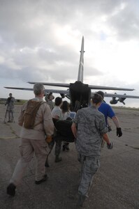 Medical personnel from New York,Tennessee, and Hawaii Disaster Medical Assistant Team (DMAT), and U.S. Air Force join together to carry litter patient to a C-130 during an exercise on 20 May 2010. Soldiers, Airmen, Seamen, and Civilians participate in the USNORTHCOM Exercise Ardent Sentry 10.