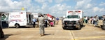 Ambulances from local hospitals pull up next to the disaster aeromedical staging facility to offload simulated patients during an evacuation exercise May 20, 2010, at the New Orleans Lakefront Airport, La. The exercise was controlled by officials from the Louisiana Department of Health and Hospitals with the help of multiple military counterparts including Air Mobility Command and U.S. Transportation Command members from Scott Air Force Base, Ill.