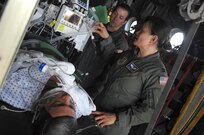 Tech Sgt. Eric Emmett from 146th Aeromedical Evacuation Squadron, Channel Islands Air National Guard Station, California and Capt. Juvelyn Chua from 375th Aeromedical Evacuation Squadron, Scott Air Force Base, Illinois, treat a mannequin onboard a C-130 during an exercise on 20 May 2010. Soldiers, Airmen, Seamen, and Civilians participate in the USNORTHCOM Exercise Ardent Sentry 10.