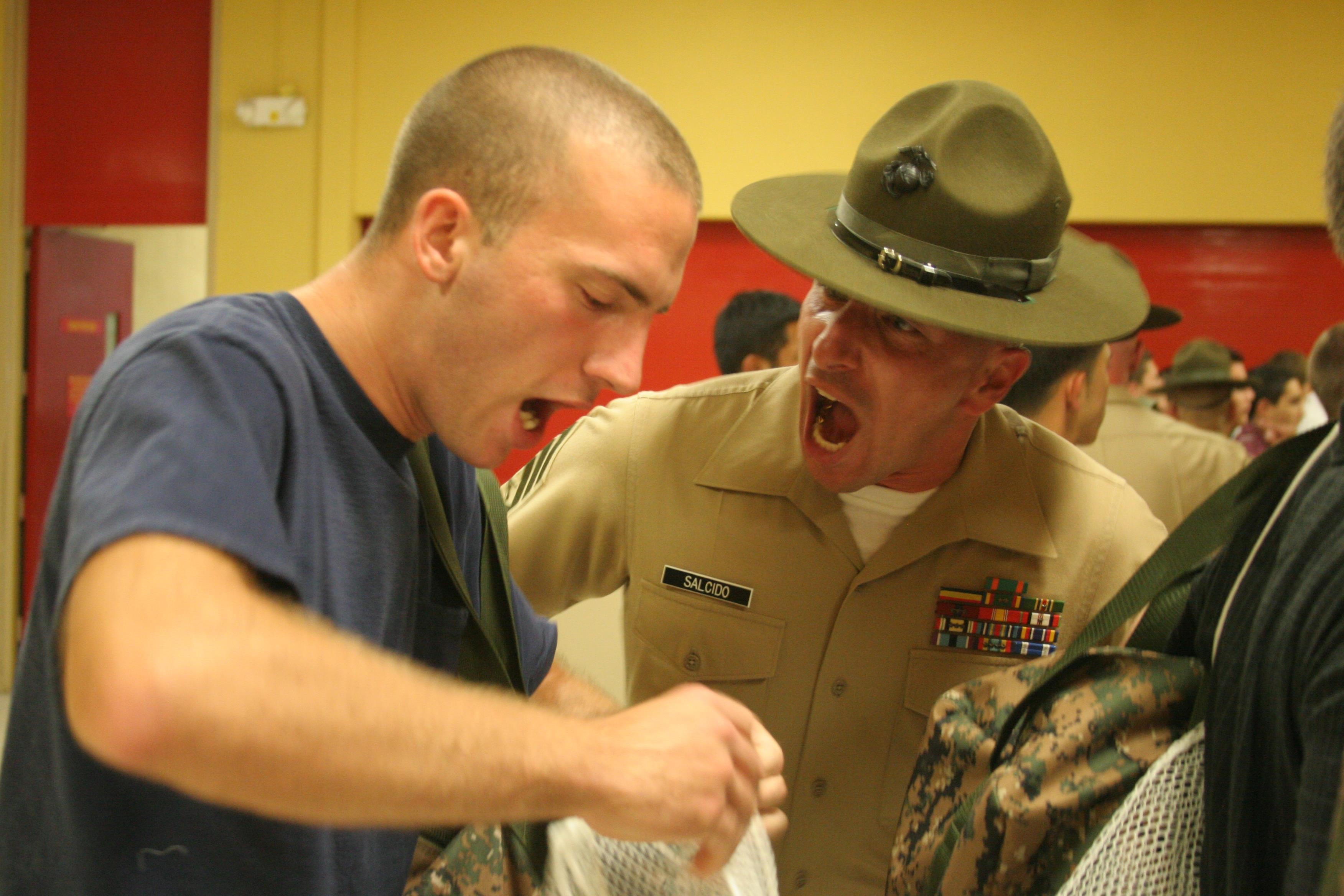 Staff Sgt. Patrick C. Salcido, chief drill instructor, receiving company, Support Battalion, yells at a recruit after he failed to properly follow instructions during receiving week aboard Marine Corps Recruit Depot San Diego June 17. Recruits are expected to move with speed and intensity at all times during recruit training.
