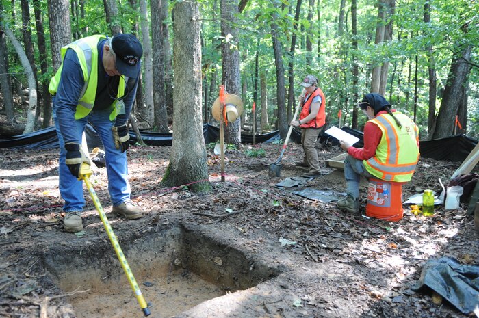 Quantico's archaeologist, Catherine Roberts, center, works with contractors to dig up Native American artifacts along Russell Road in preparation for the road's widening. 