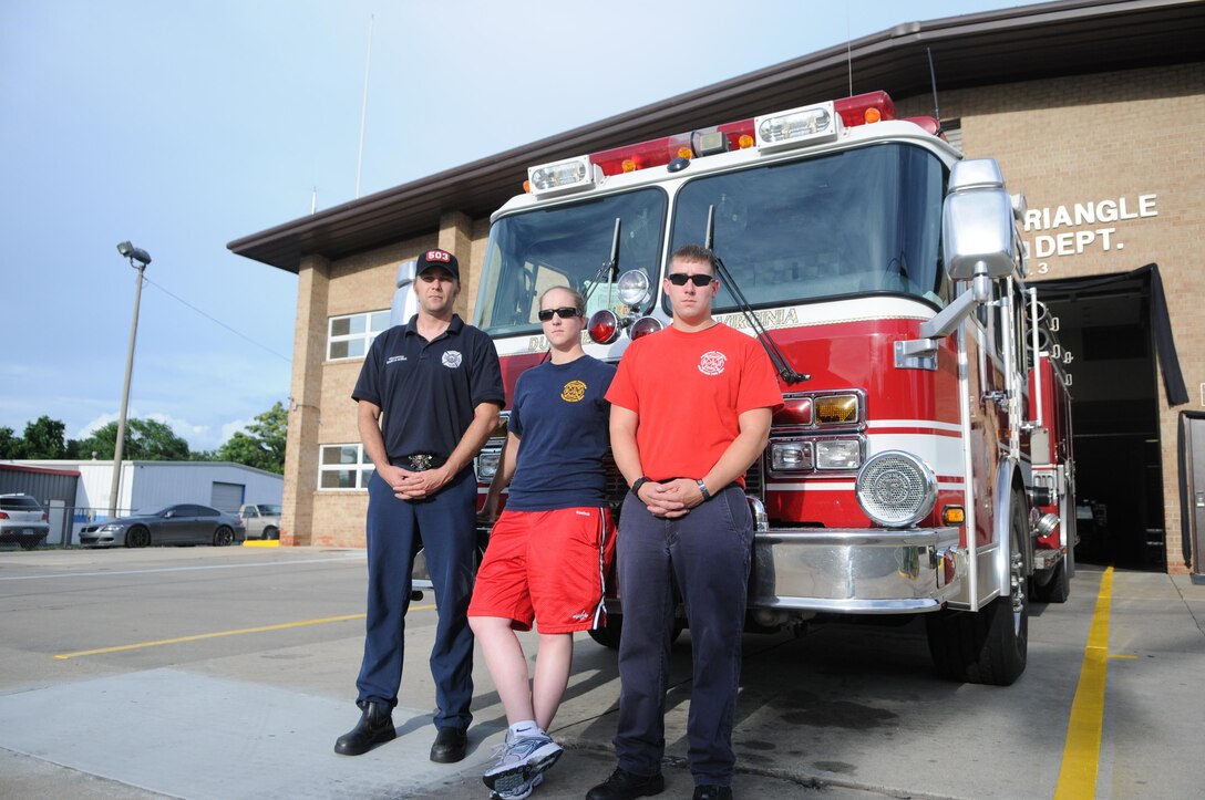 From left, Shawn Bowen, a civilian at Marine Corps Intelligence Activity; Cpl. Stefanie Thelin, an avionics technician at Marine Helicopter Squadron 1; and Sgt. Luke Budo, warfighting instructor at The Basic School, are ready for their overnight shift at Dumfries-Triangle Volunteer Fire Department Station 3-F on July 1, 2013. 