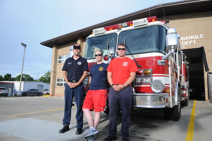 From left, Shawn Bowen, a civilian at Marine Corps Intelligence Activity; Cpl. Stefanie Thelin, an avionics technician at Marine Helicopter Squadron 1; and Sgt. Luke Budo, warfighting instructor at The Basic School, are ready for their overnight shift at Dumfries-Triangle Volunteer Fire Department Station 3-F on July 1, 2013. 