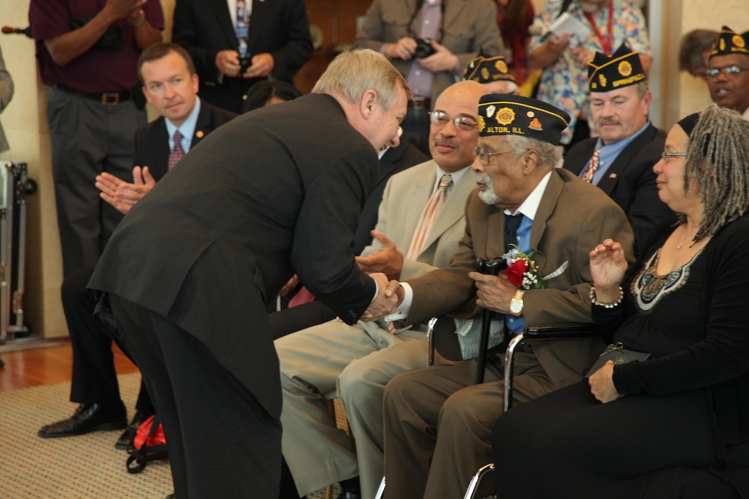 Sen. Dick Durbin shakes the hand of Cpl. (ret) Deloyce McMurray during a Montford Point Marine ceremony in which he was presented the Congressional Gold Medal July 2 at the Abraham Lincoln Presidential Library. McMurray enlisted in the Marine Corps in 1944 and was one of the few African Americans sent to the segregated Montford Point, North Carolina for basic training. McMurray was deployed to the Pacific during World War II seeing action during the battle of Iwo Jima. (U.S. Marine Corps photo by Cpl. Erik S. Brooks Jr./ Released)