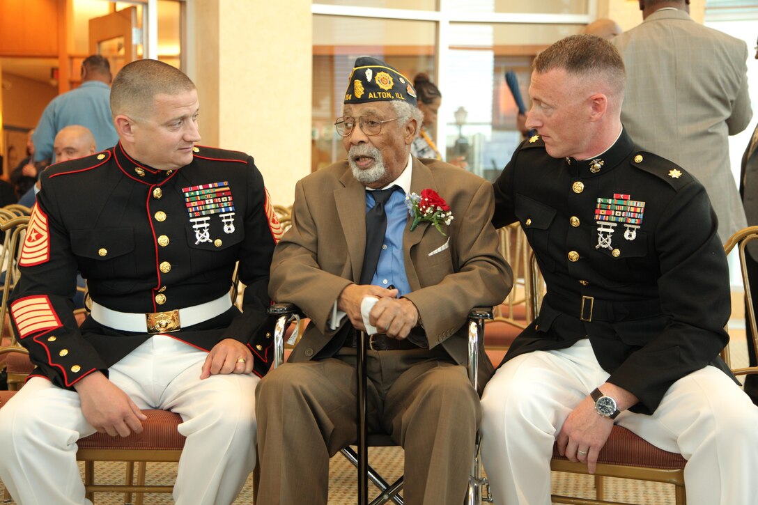 Cpl. (ret) Deloyce McMurray, seated center, speaks with Maj Gregory P. Gordon and SgtMaj Christopher G. Combs during a Montford Point Marine ceremony in which he was presented the Congressional Gold Medal July 2 at the Abraham Lincoln Presidential Library. McMurray enlisted in the Marine Corps in 1944 and was one of the few African Americans sent to the segregated Montford Point, North Carolina for basic training. McMurray was deployed to the Pacific during World War II seeing action during the battle of Iwo Jima. (U.S. Marine Corps photo by Cpl. Erik S. Brooks Jr./ Released)