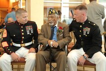 Cpl. (ret) Deloyce McMurray, seated center, speaks with Maj Gregory P. Gordon and SgtMaj Christopher G. Combs during a Montford Point Marine ceremony in which he was presented the Congressional Gold Medal July 2 at the Abraham Lincoln Presidential Library. McMurray enlisted in the Marine Corps in 1944 and was one of the few African Americans sent to the segregated Montford Point, North Carolina for basic training. McMurray was deployed to the Pacific during World War II seeing action during the battle of Iwo Jima. (U.S. Marine Corps photo by Cpl. Erik S. Brooks Jr./ Released)