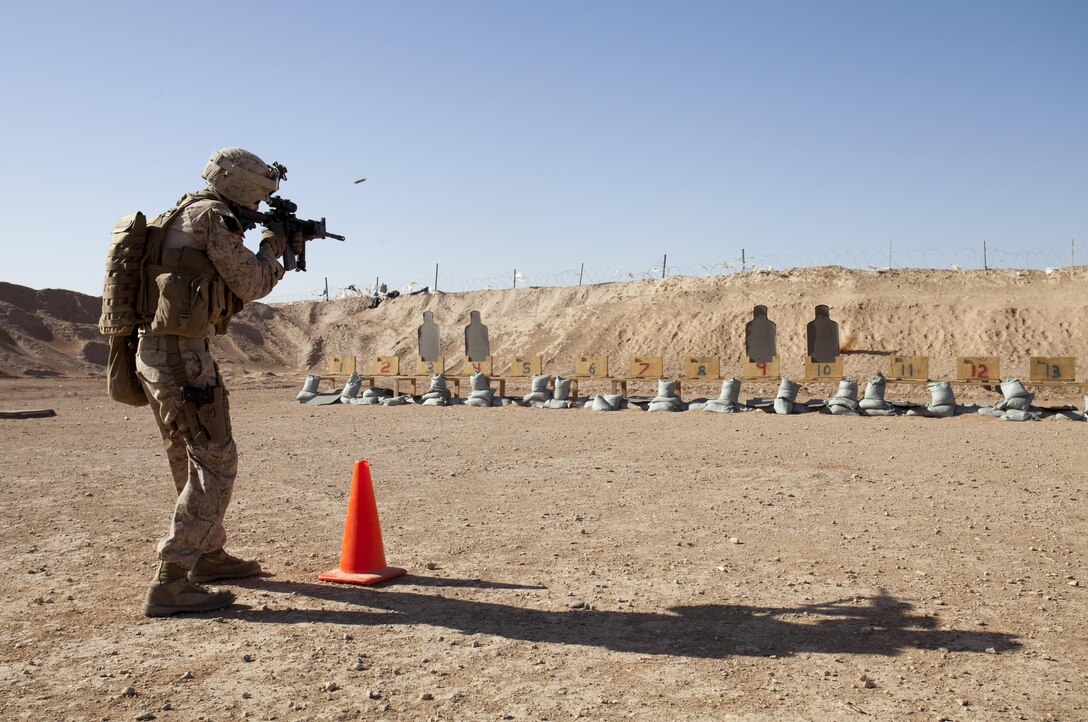 U.S. Navy Petty Officer 3rd class Andrew Vigil, a hospital corpsman assigned to the Afghan National Civil Order Police Kandak 1, engages multiple targets during a live fire shooting package on Camp Leatherneck, Helmand province, Afghanistan, June 8, 2013. The Marines conducted the training to prepare them for situations they may encounter while conducting missions in support of Operation Enduring Freedom. (U.S. Marine Corps photo by Staff Sgt. Ezekiel R. Kitandwe/Released)