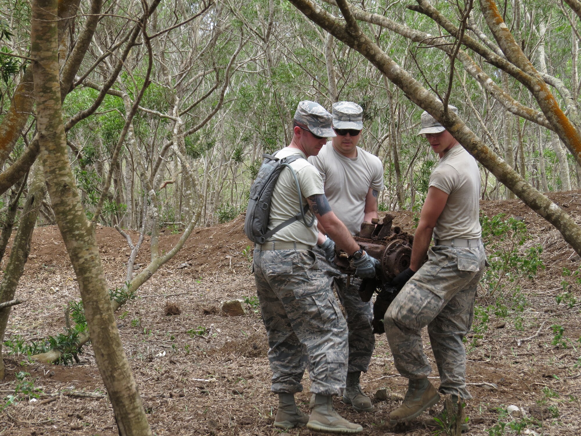 LANAI, Hawaii -- Military members remove junk off a land here from years of illegal dumping June 7, 2013, between medical training. Over 540 military personnel from multiple components of the Air Force, Army and Navy gathered on four Hawaiian Islands at six sites as part of a joint training mission called TROPIC CARE 2013 –  an Innovative Readiness Training project June 4 to 12, 2013, to care for medically-underserved Hawaiians. Photo by Ron Gingerich.