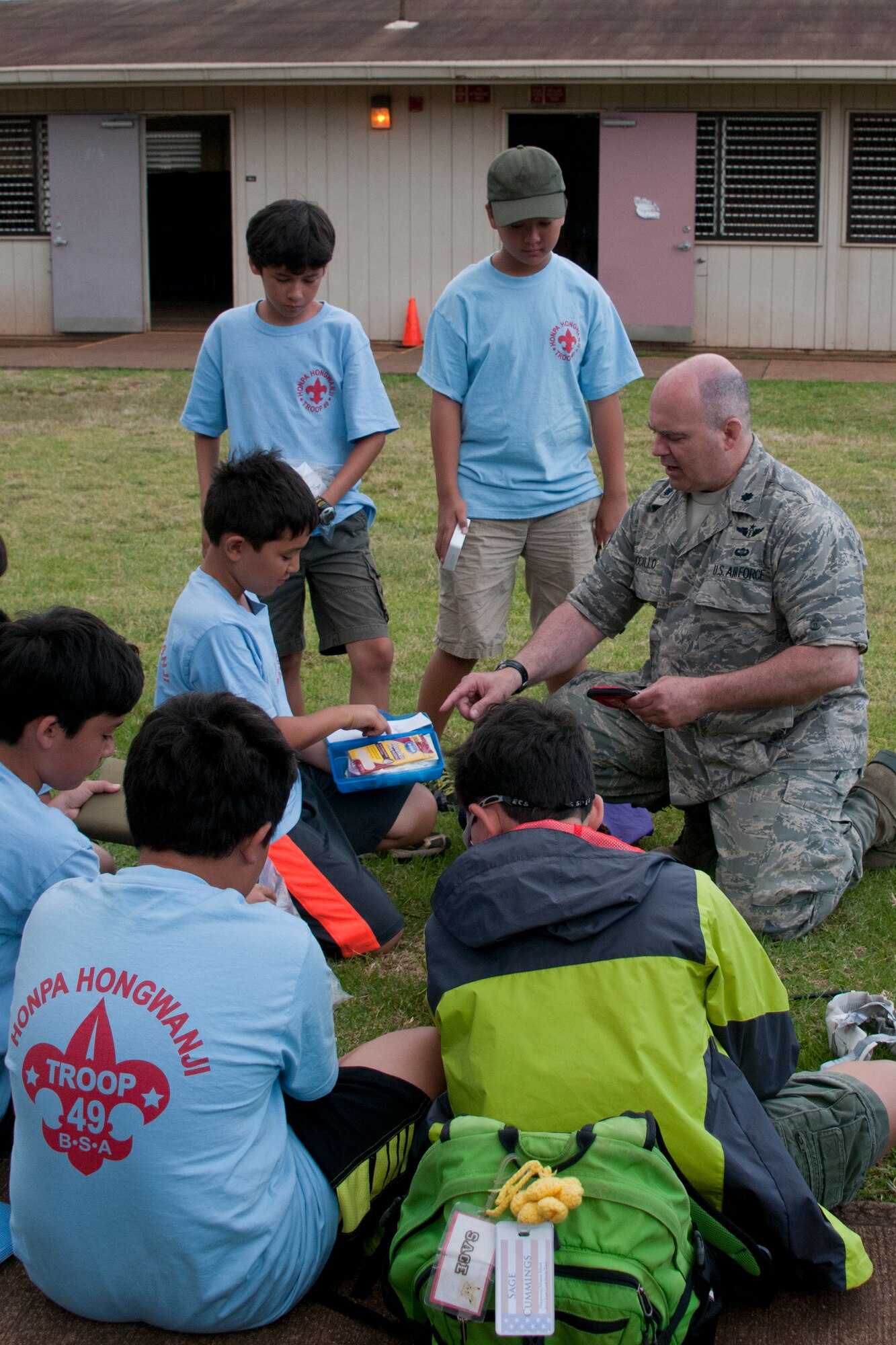 LANAI, Hawaii - Lt. Col. Mark Tucillo, a physician from the 176 Medical Group, assists a local Boy Scout Troop June 8, 2013, earn the first aid badge. Forty-five Alaska military personnel from Air and Army National Guard and active-duty Air Force set up and ran medical clinics for medically-underserved Hawaiians on the islands of Lanai and Maui as part of an Innovative Readiness Training project June 4 to 12. The group joined about 500 other military personnel from multiple components of the Air Force, Army and Navy on four Hawaiian Islands at six sites as a joint training mission called TROPIC CARE 2013 – the largest IRT mission since the program began. National Guard photo by Staff Sgt. N. Alicia Goldberger.