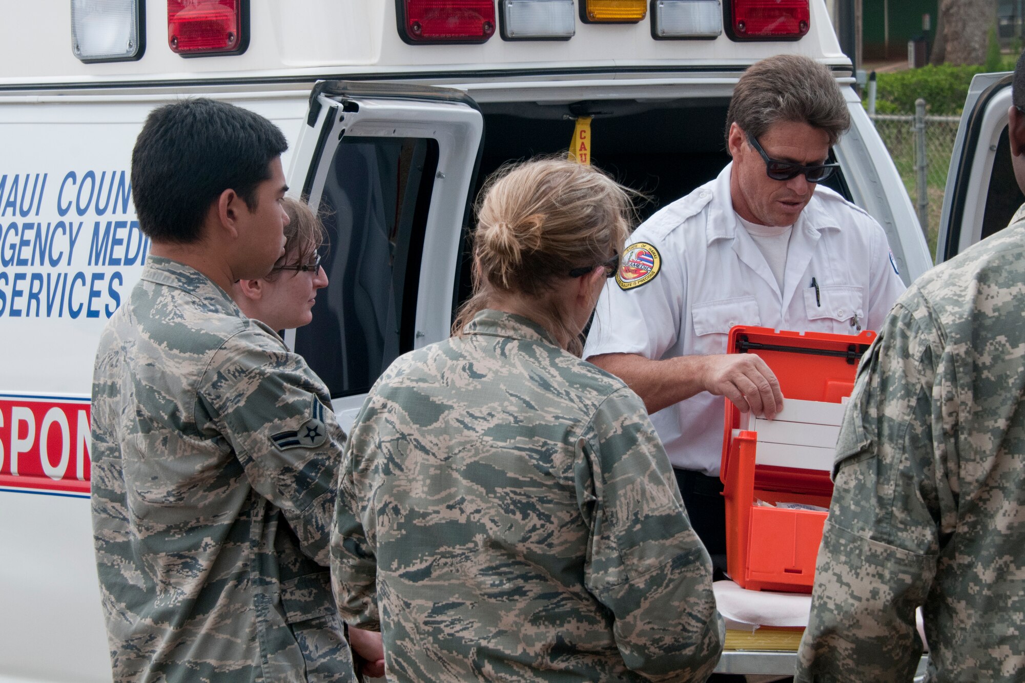 LANAI, Hawaii - Local ambulance drivers explained the equipment and proceses of their small, island town here June 6, 2013, to military members in the no-hat, no-salute area -- towns like these share some similarities to rural, Alaskan villages. Forty-five Alaska military personnel from Air and Army National Guard and active-duty Air Force set up and ran medical clinics for medically-underserved Hawaiians on the islands of Lanai and Maui as part of an Innovative Readiness Training project June 4 to 12. The group joined about 500 other military personnel from multiple components of the Air Force, Army and Navy on four Hawaiian Islands at six sites as a joint training mission called TROPIC CARE 2013 – the largest IRT mission since the program began. National Guard photo by Staff Sgt. N. Alicia Goldberger.